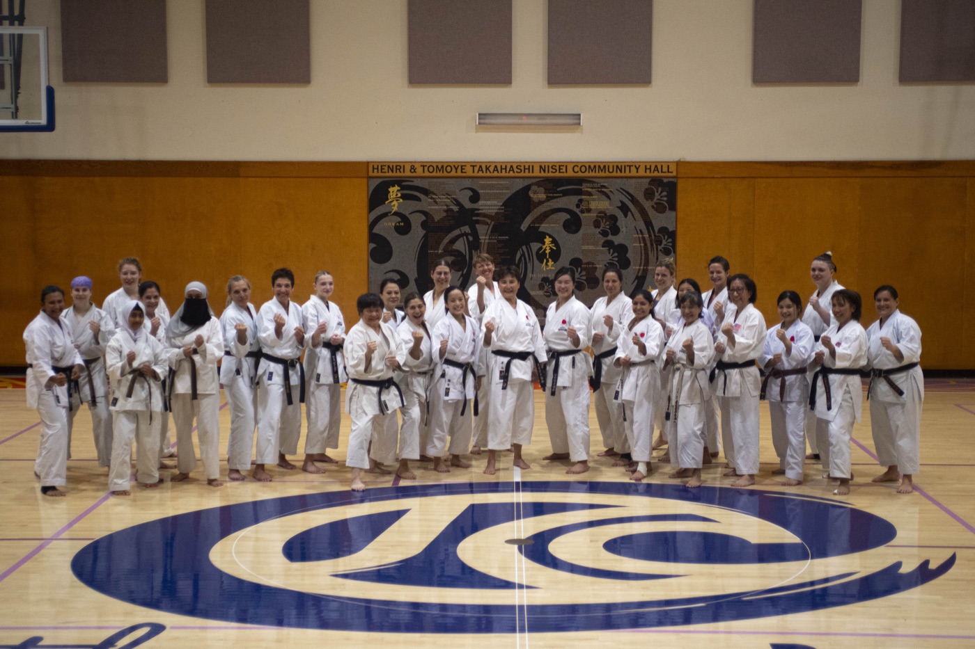 The full camp group photographed together on the dojo floor